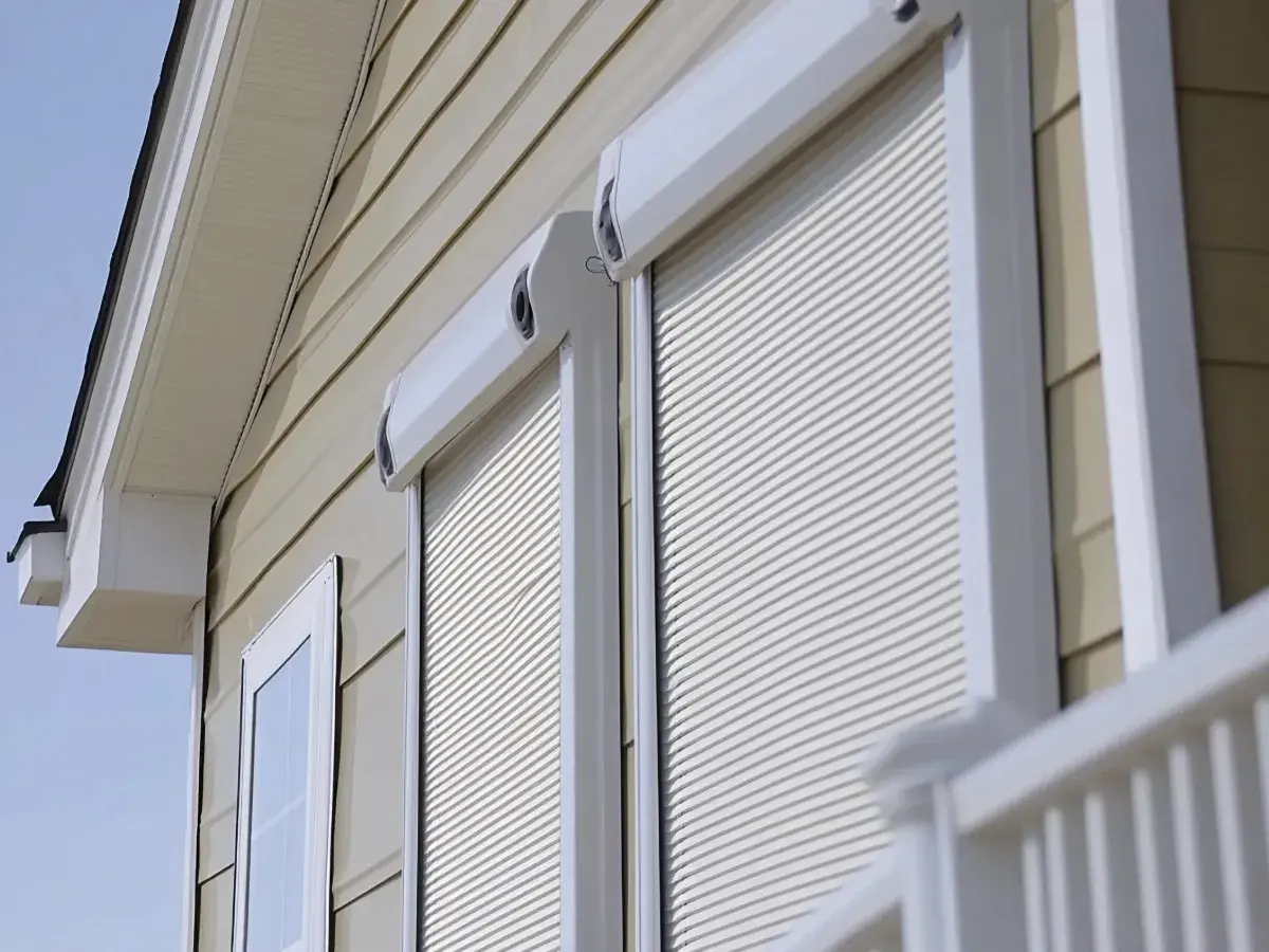 Hurricane shutters rolled down over house windows