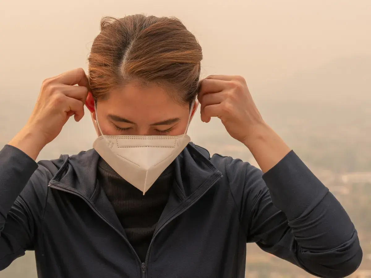 Person putting on an N95 mask