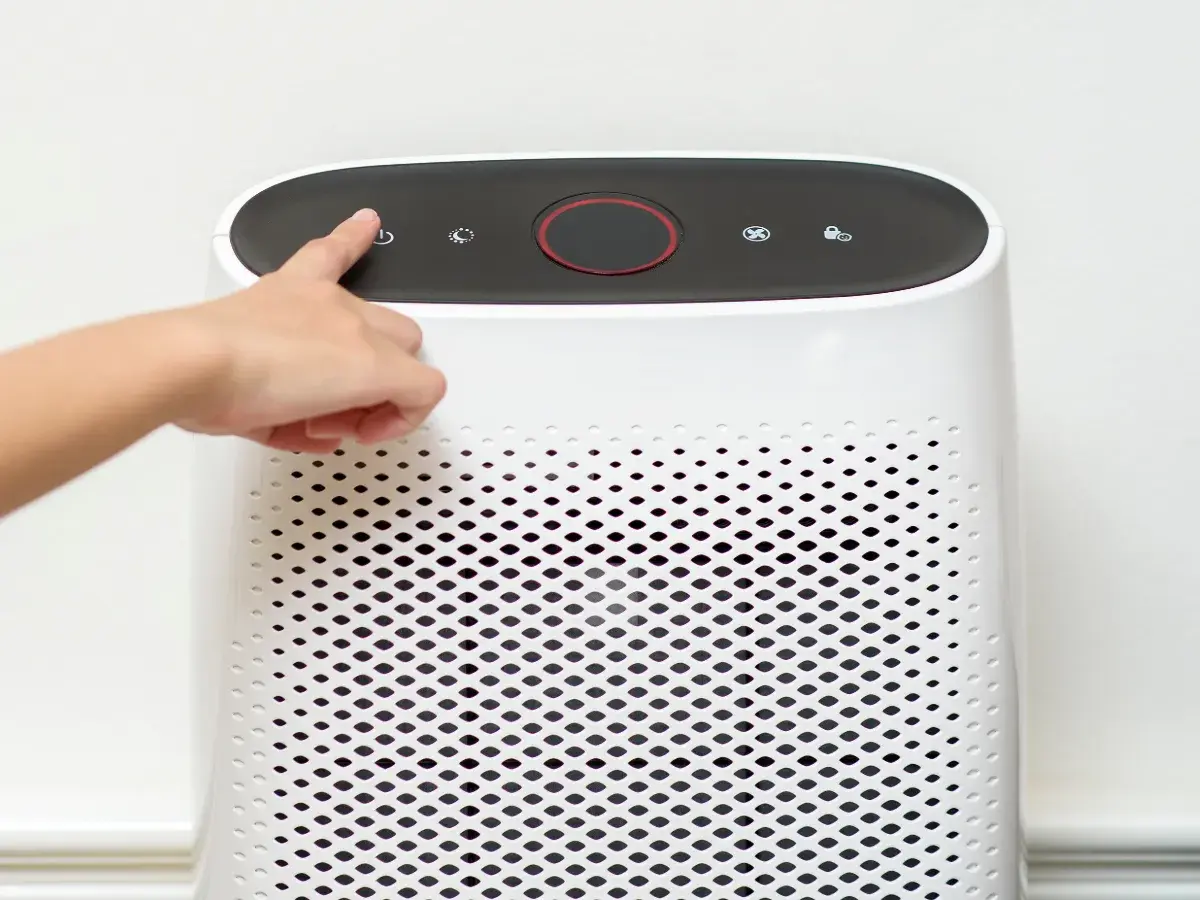 Person turning on an air cleaner